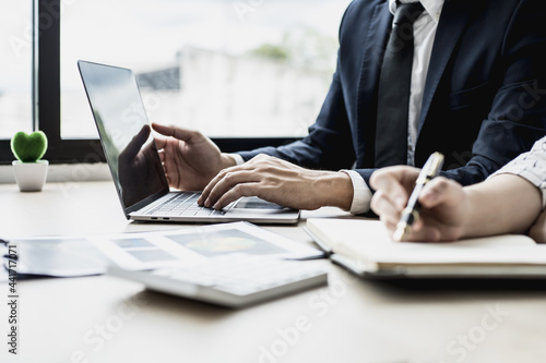 Two staff members of the finance department are sharing monthly financial statements together, they are working on a monthly summary report for their monthly meetings with management.