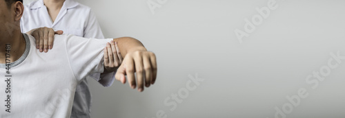 Obraz na plátně A professional physiotherapist is doing stretching for a patient, the patient has muscle dysfunction due to hard work, most often an office worker who has problems sitting for long periods of time