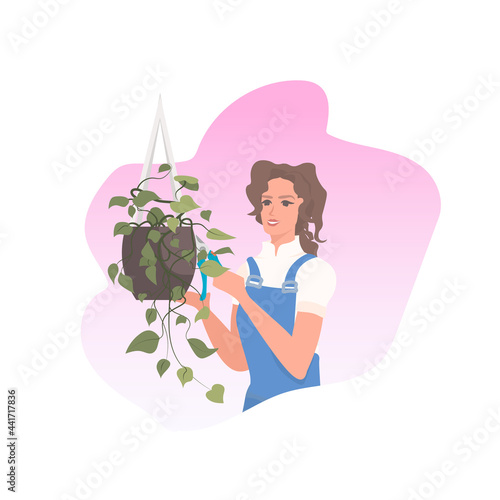 female gardener using pruners cutting houseplants garden work with branches and foliage