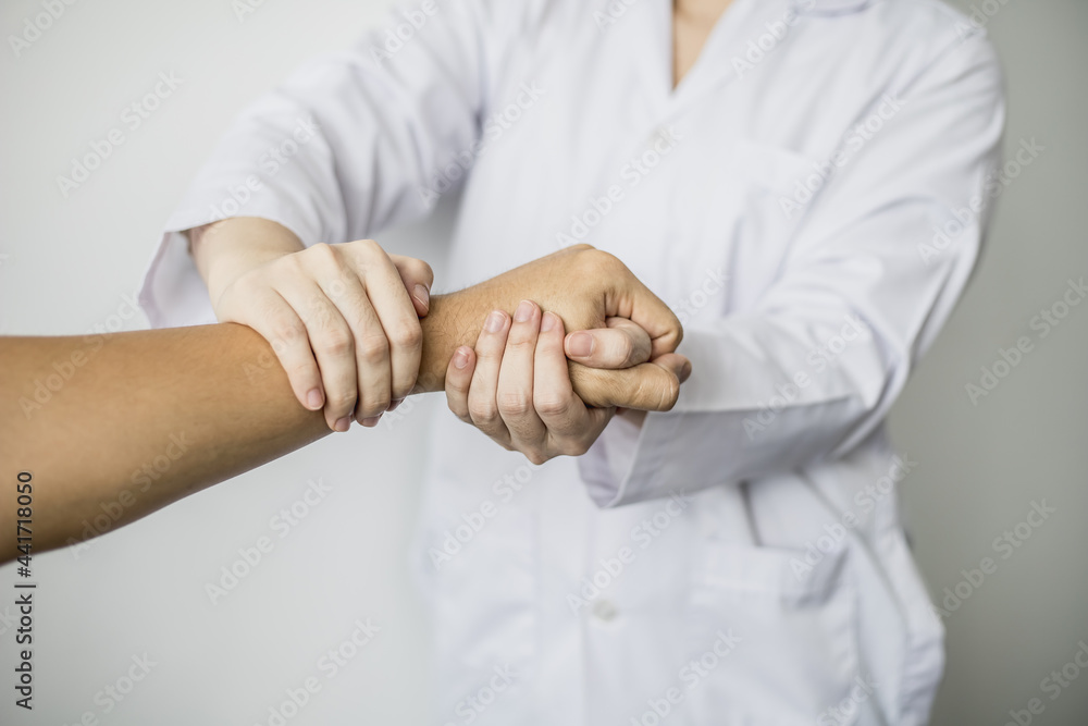 A professional physiotherapist is doing a massage to loosen the hand muscles of patients undergoing therapy, most patients are office workers who sit for long periods of time causing pain. A professional physiotherapist is doing a massage to loosen the hand muscles of patients undergoing therapy, most patients are office workers who sit for long periods of time causing pain.