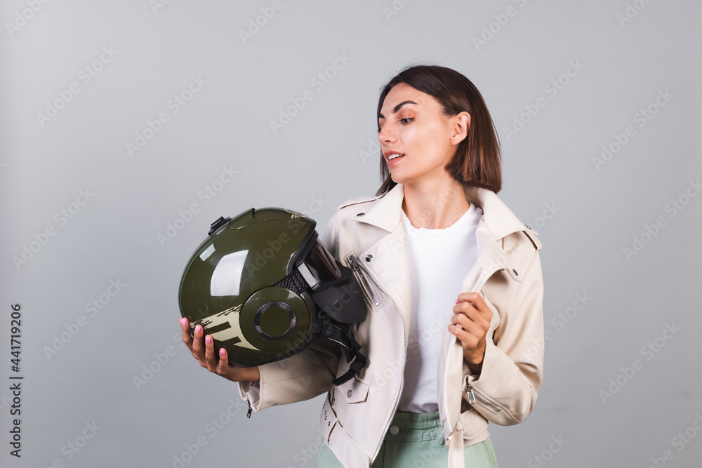Naklejka premium Woman in leather jacket and helmet on gray background