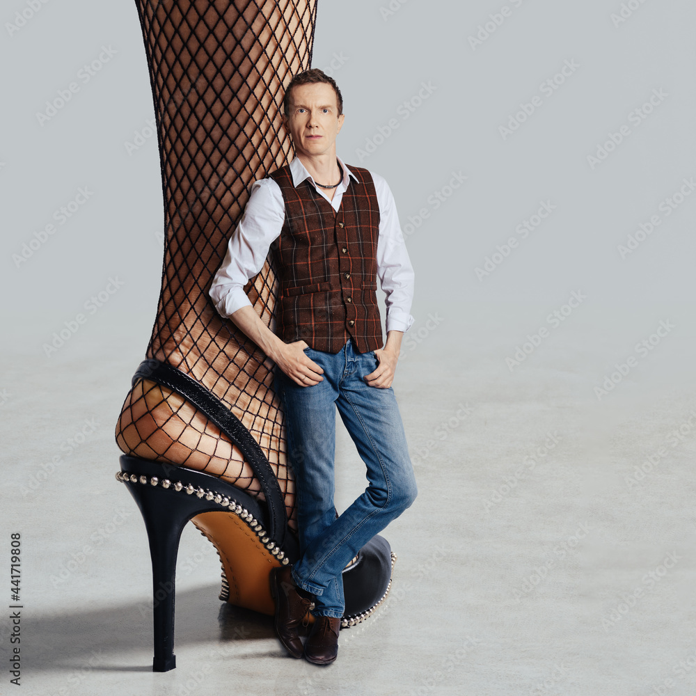 Fishnet Slang Man in jeans and vest leaning to female leg in fishnet tights and open ...