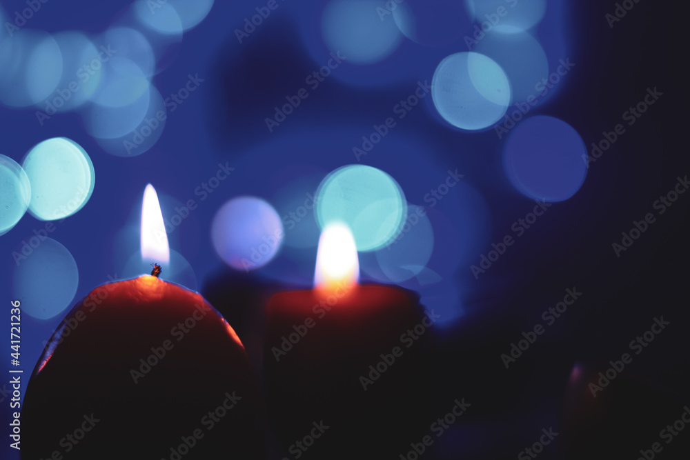 Candle lights in darkness with colorful light effects and bokeh for solemn moments and wallpaper. Candle flame light at night with the background. Candle lights in darkness with colorful light effects and bokeh for solemn moments and wallpaper. Candle flame light at night with the background.
