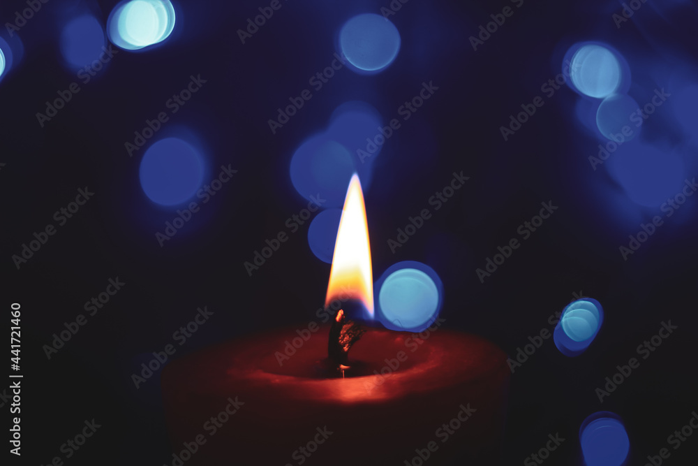 Candle lights in darkness with colorful light effects and bokeh for solemn moments and wallpaper. Candle flame light at night with the background. Candle lights in darkness with colorful light effects and bokeh for solemn moments and wallpaper. Candle flame light at night with the background.