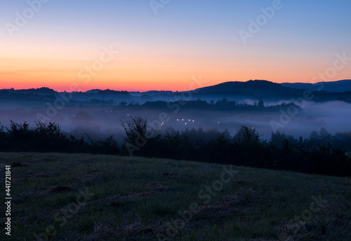 Fototapeta Naklejka Na Ścianę i Meble -  Just before sunrise, a view of meadows shrouded in mist