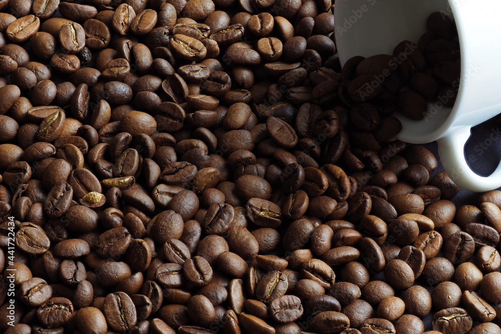 Fototapeta premium Black coffee beans with white coffee cup