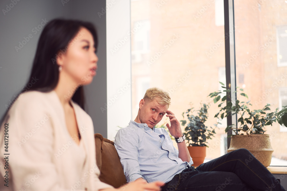 Multiracial couple having argument during psychotherapy session Multiracial couple having argument during psychotherapy session