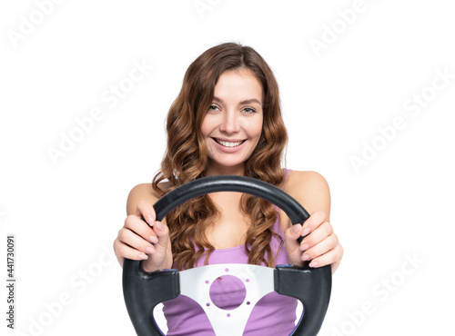 фотографія Young happy smiling girl holding car steering wheel with hands, front view, isolated on white background