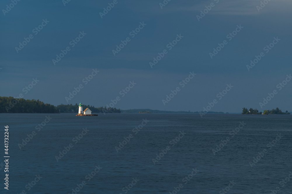 Sunken Rock Lighthouse near Boldt Castle on the Saint Lawrence River near the town of Alexandria Bay, NY, is illumniated by a morning sunrise.