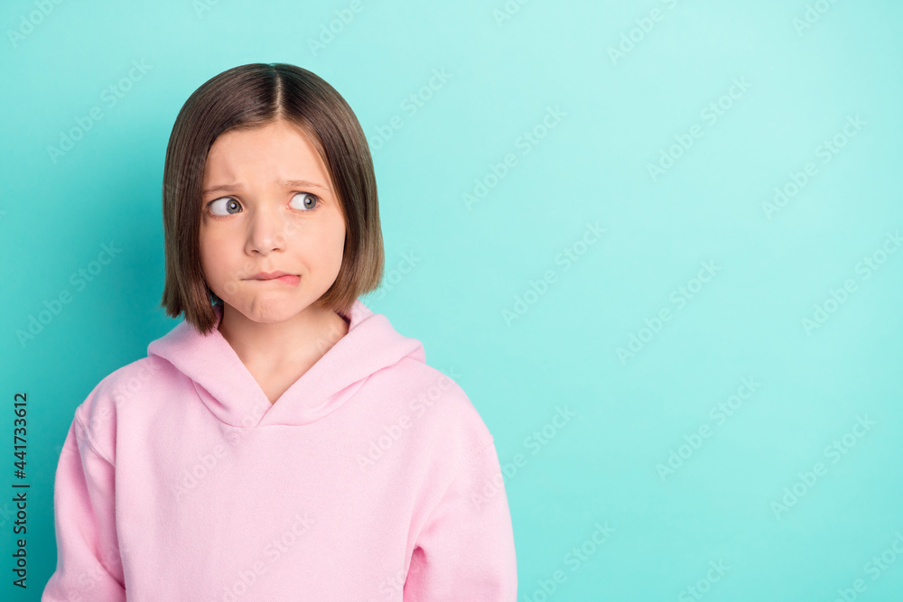 Fototapeta premium Photo of sad short hairdo little girl look empty space wear pink sportswear isolated on teal color background