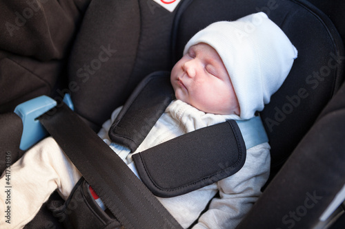 New born baby sleeping inside of car safety seat, close up view