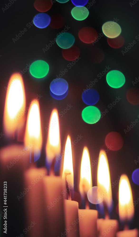 Candle lights in darkness with light effects and bokeh for solemn moments and wallpaper. Candle flame light at night with the background. Candle lights in darkness with light effects and bokeh for solemn moments and wallpaper. Candle flame light at night with the background.