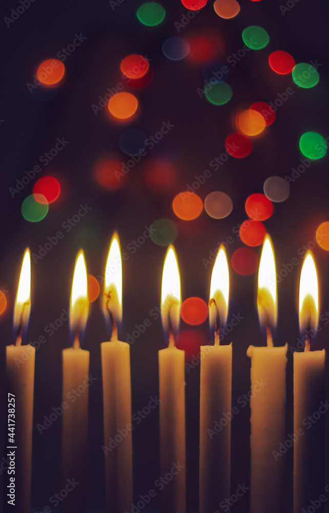 Candle lights in darkness with light effects and bokeh for solemn moments and wallpaper. Candle flame light at night with the background. Candle lights in darkness with light effects and bokeh for solemn moments and wallpaper. Candle flame light at night with the background.