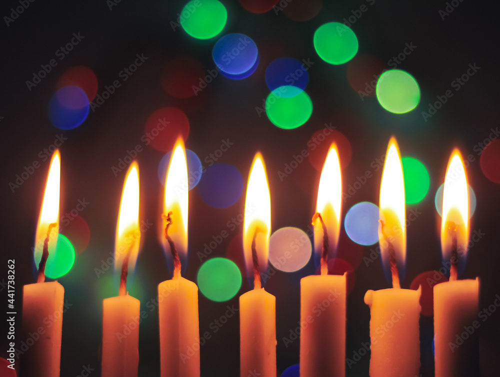 Candle lights in darkness with light effects and bokeh for solemn moments and wallpaper. Candle flame light at night with the background. Candle lights in darkness with light effects and bokeh for solemn moments and wallpaper. Candle flame light at night with the background.