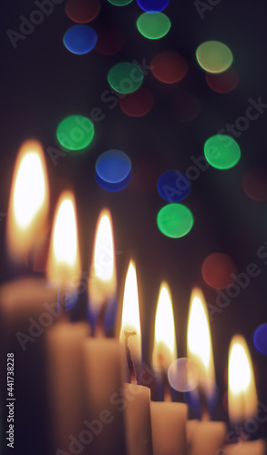 Candle lights in darkness with light effects and bokeh for solemn moments and wallpaper. Candle flame light at night with the background.