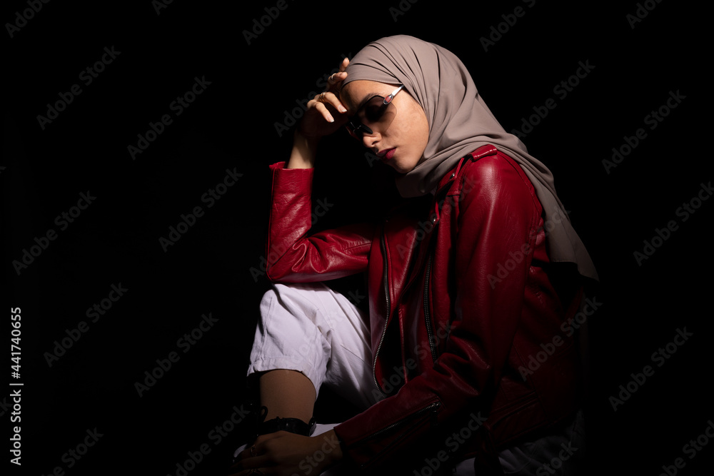 Stylish Muslim woman touching face in studio Stylish Muslim woman touching face in studio