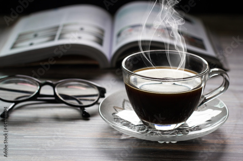 hot coffee and a book with glasses.