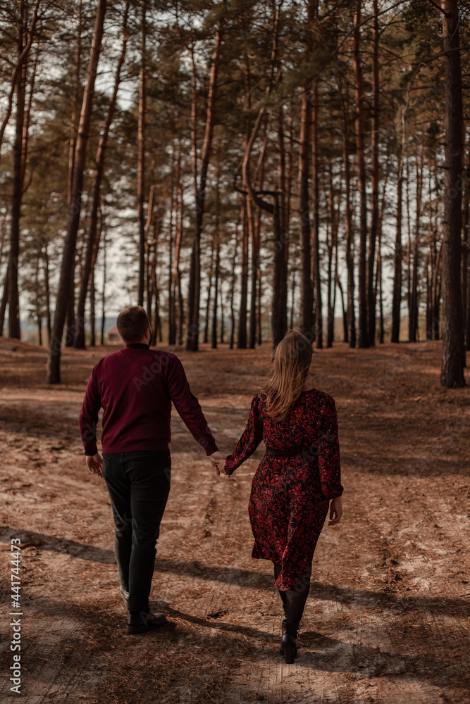 young couple walking together by the road young couple walking together by the road
