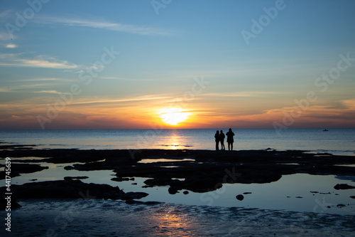 silhouette of a person on a beach at sunset