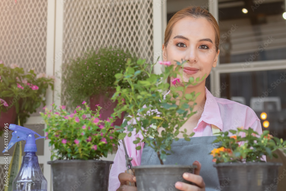 Smile, happiness of young asian women, girl gardener pruning shrubs, take care flowers of pot plants, engaging hobby at home. Love gardening of plants and care. Owner small business concept. Smile, happiness of young asian women, girl gardener pruning shrubs, take care flowers of pot plants, engaging hobby at home. Love gardening of plants and care. Owner small business concept.