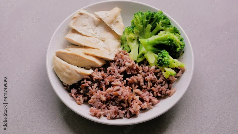dolly shot Riceberry, boiled chicken breast and Broccoli on whiteplate