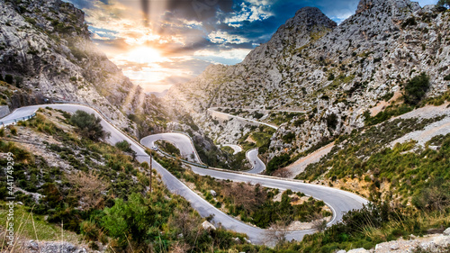 Serpentine Road with sunset and some cyclist at majorca, mallorca island photo
