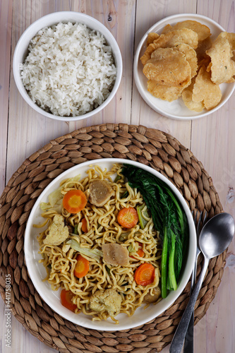 Mie goreng or Fried noodles served with vegetable. © menik