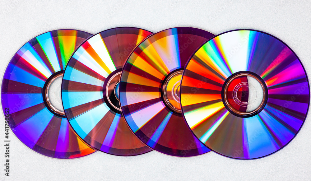Music CDs with colored reflections on the surface. DVD discs.