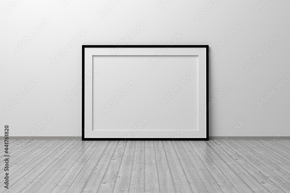 Mockup template of horizontal A4 frame with thin black frame border standing next to wall on wooden floor Mockup template of horizontal A4 frame with thin black frame border standing next to wall on wooden floor