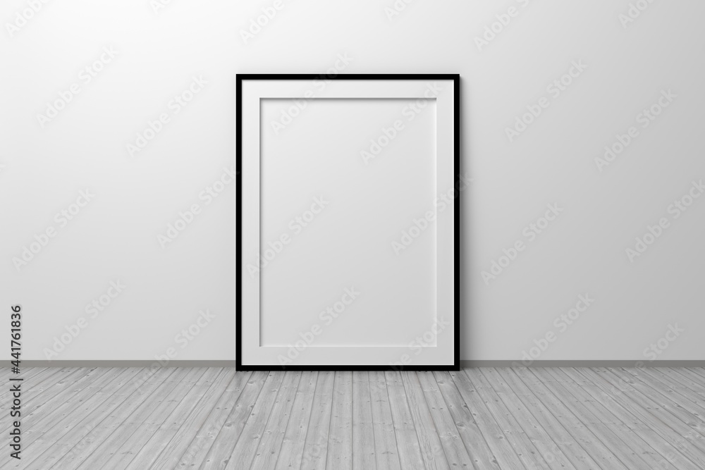 Mockup template of A4 frame with thin black frame border standing next to wall on wooden floor Mockup template of A4 frame with thin black frame border standing next to wall on wooden floor