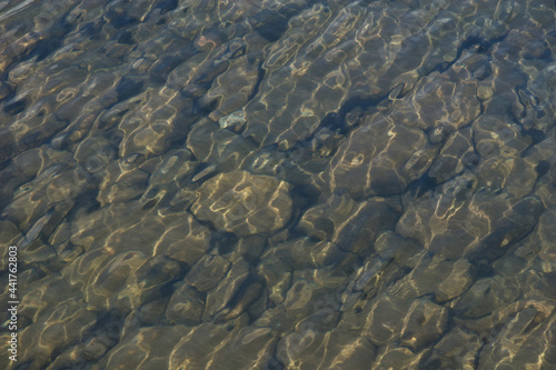 Background of large rocks under shallow water