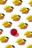 Bright pattern made with red apple and yellow lemons. Break the pattern or food concept. Modern minimal flat lay..