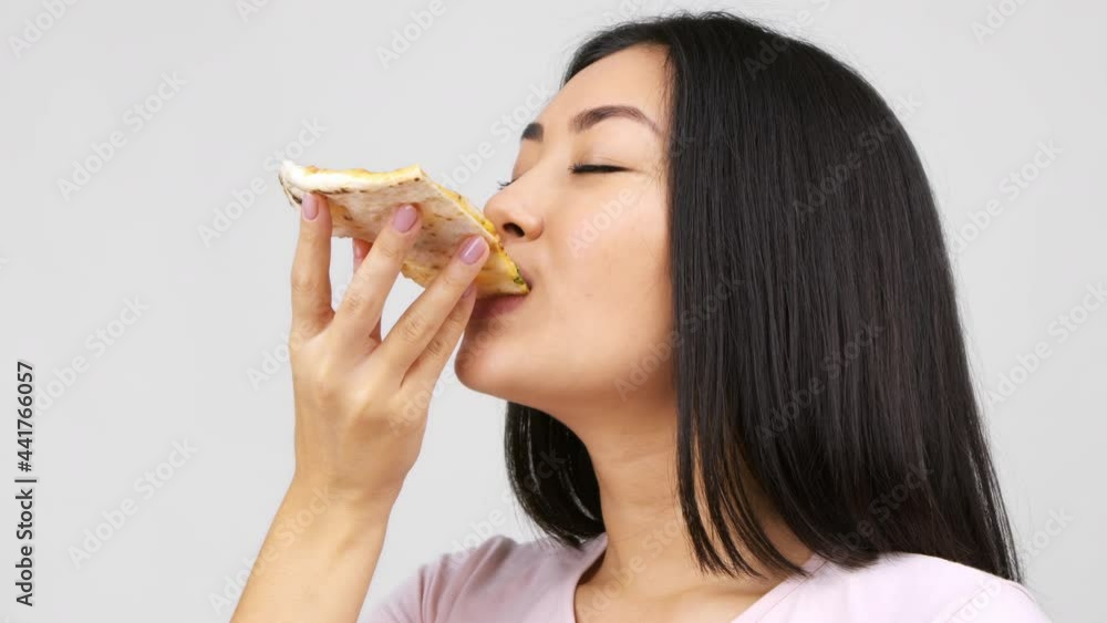 Happy Asian Lady Eating Pizza Slice Posing Over White Background Happy Asian Lady Eating Pizza Slice Posing Over White Background