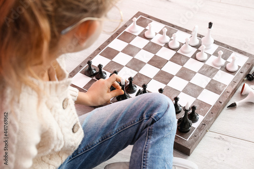 Cute little girl playing ch...