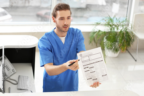 Male receptionist working in clinic photo