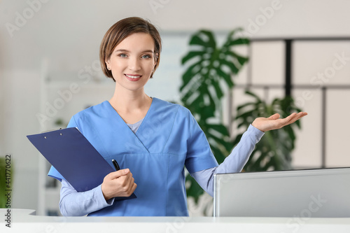 Female receptionist showing...