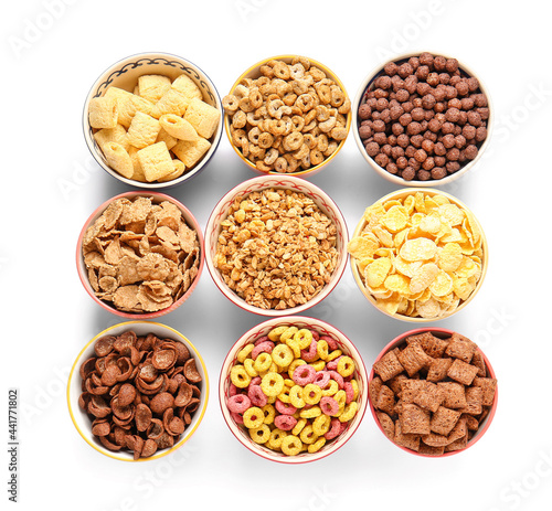 Bowls of different cereals on white background