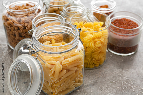 Photography Glass jars with different products on grunge background, closeup