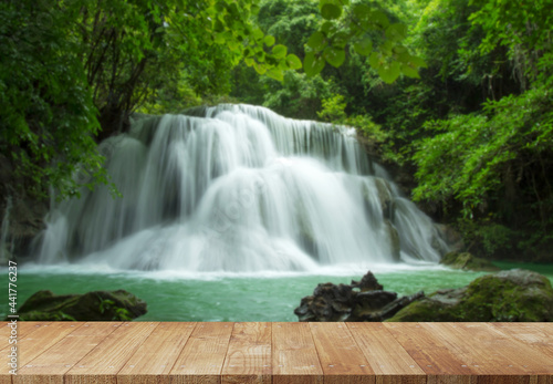 Wood platform beside the waterfall © tanatat