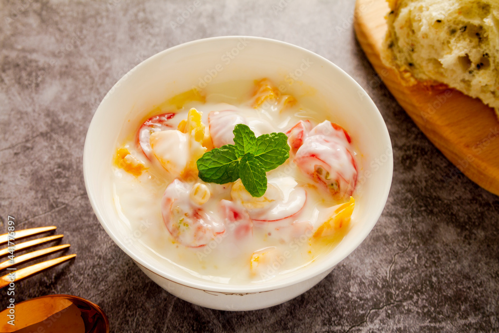 Mango and cherry tomato yogurt close up. Mango and cherry tomato yogurt close up.