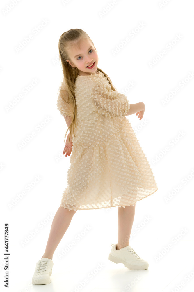 A cheerful little girl is dancing.The concept of a school of dance. A cheerful little girl is dancing.The concept of a school of dance.