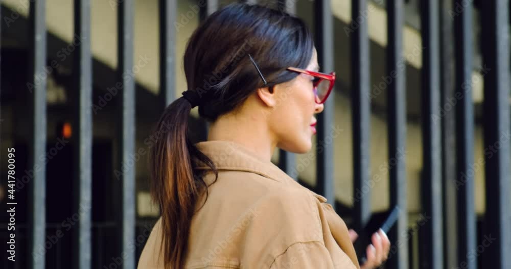 Woman Trendy Red Sunglasses Walks the Central City Street and Uses her Phone. Woman with Smart Phone. Pretty Woman in Jacket Red Lipstick on the Lips. Sexy Girl, Feminism Red Shoes Coffee Secretary Woman Trendy Red Sunglasses Walks the Central City Street and Uses her Phone. Woman with Smart Phone. Pretty Woman in Jacket Red Lipstick on the Lips. Sexy Girl, Feminism Red Shoes Coffee Secretary