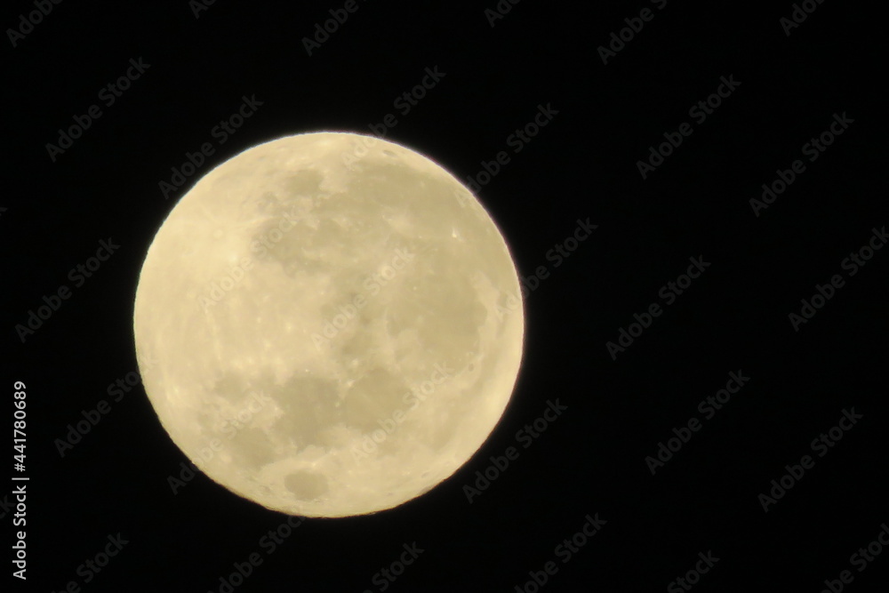 Closeup of a beautiful full moon surrounded by pitch black sky Closeup of a beautiful full moon surrounded by pitch black sky