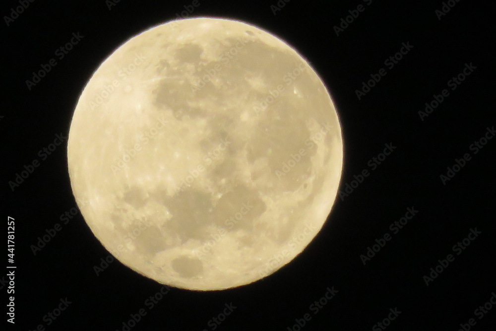 Closeup of a beautiful full moon surrounded by pitch black sky Closeup of a beautiful full moon surrounded by pitch black sky