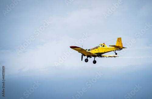 Fototapeta Naklejka Na Ścianę i Meble -  The plane is dusting mosquitoes from the air