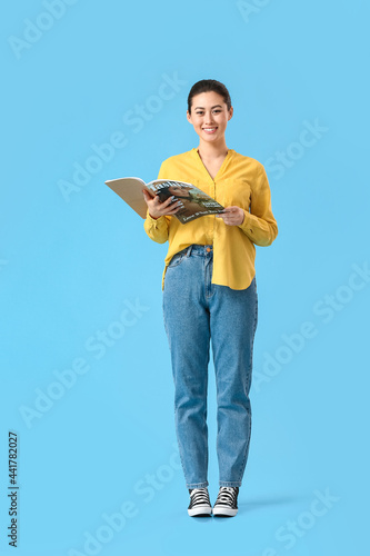 Young woman with magazine o...