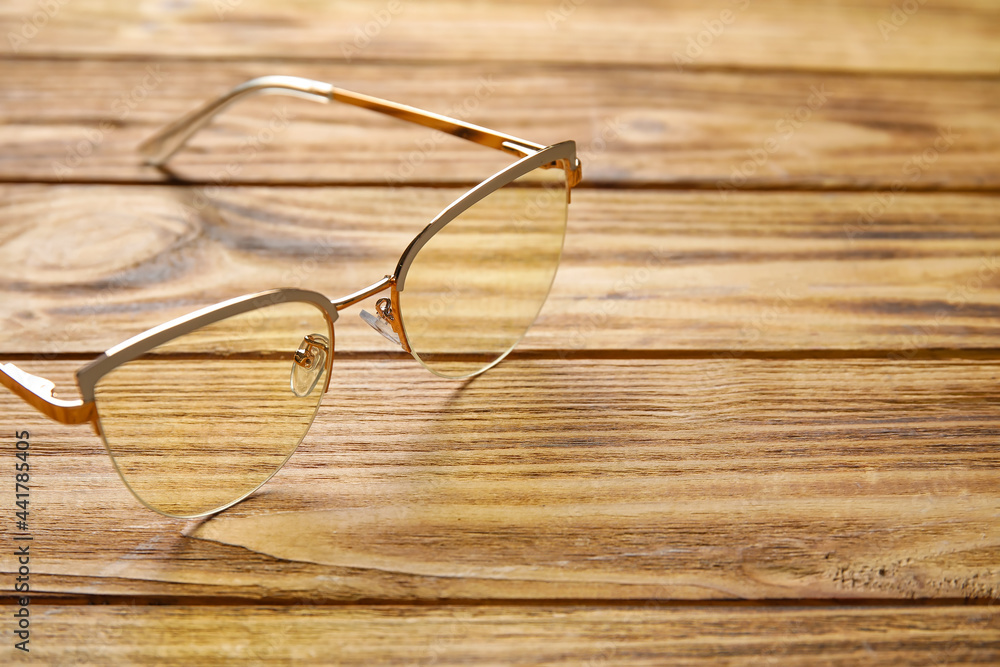 Stylish eyeglasses on wooden background, closeup Stylish eyeglasses on wooden background, closeup