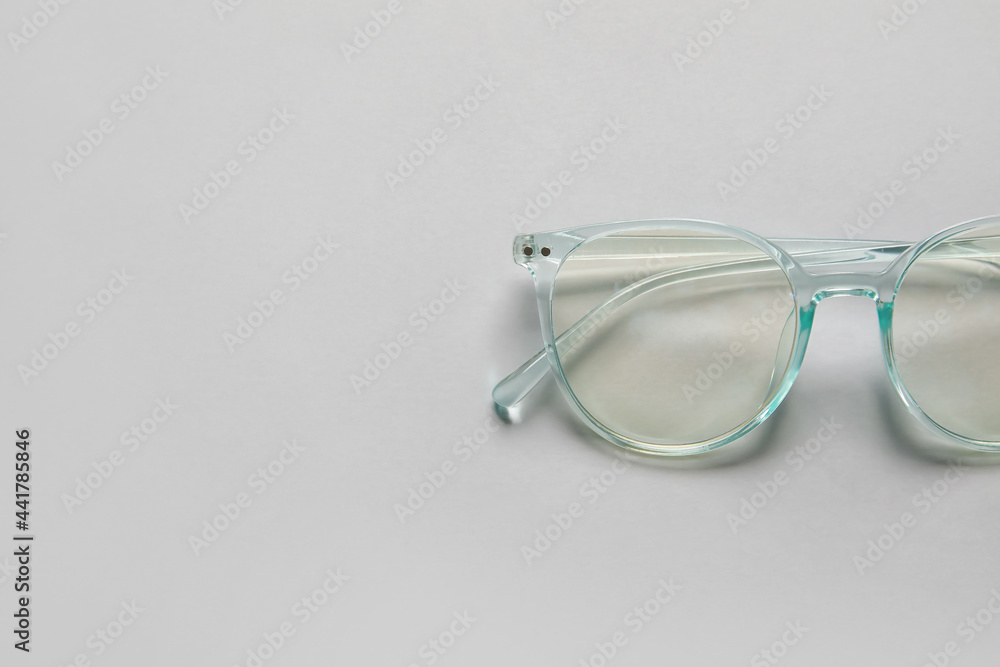 Stylish eyeglasses on light background, closeup Stylish eyeglasses on light background, closeup