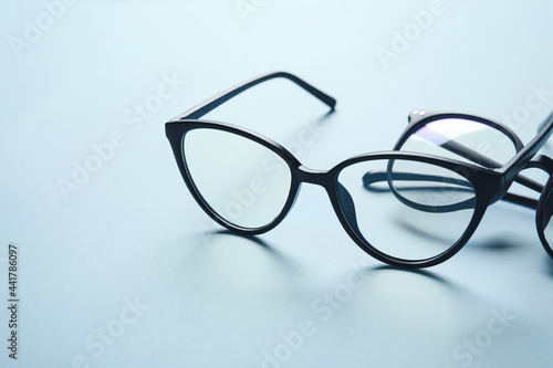 Different stylish eyeglasses on color background, closeup