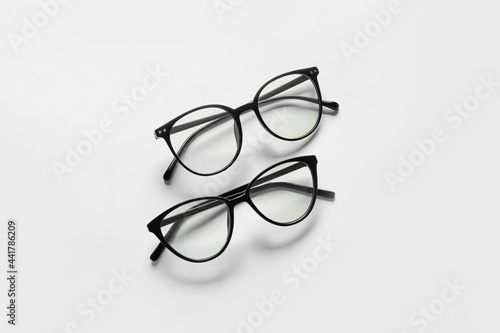 Different stylish eyeglasses on white background